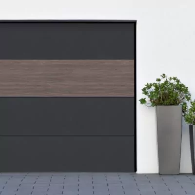 Modern gray garage, next to the Scandinavian-style house. Private garage with automatic door in a European city in Germany