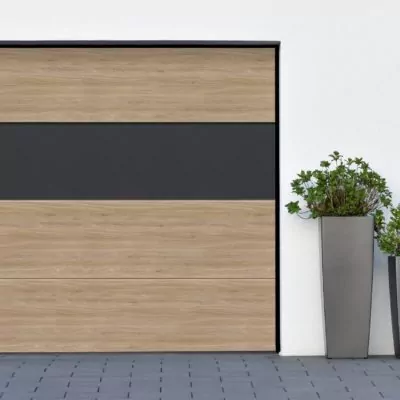 Modern gray garage, next to the Scandinavian-style house. Private garage with automatic door in a European city in Germany